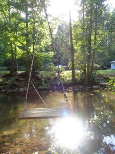 There's this guy who calls himself "The Captain" that owns a piece of property right off the AT.  Right off the AT, and across a river, that is.  If you are willing to zip line on a jerry-rigged wooden swing thingy across the river, you are welcome to camp on his property, free of charge.  Did I sit my booty on this contraption and lamely fly across the river??  ...Of course I did!